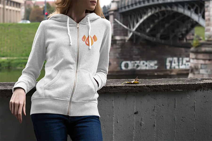 heather-full-zip-hoodie-mockup-featuring-a-woman-by-a-bridge-3568-el1