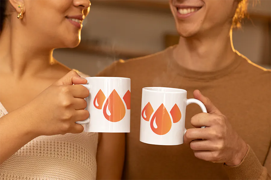 mockup-of-a-smiling-cropped-face-man-and-woman-holding-two-coffee-mugs-m38239