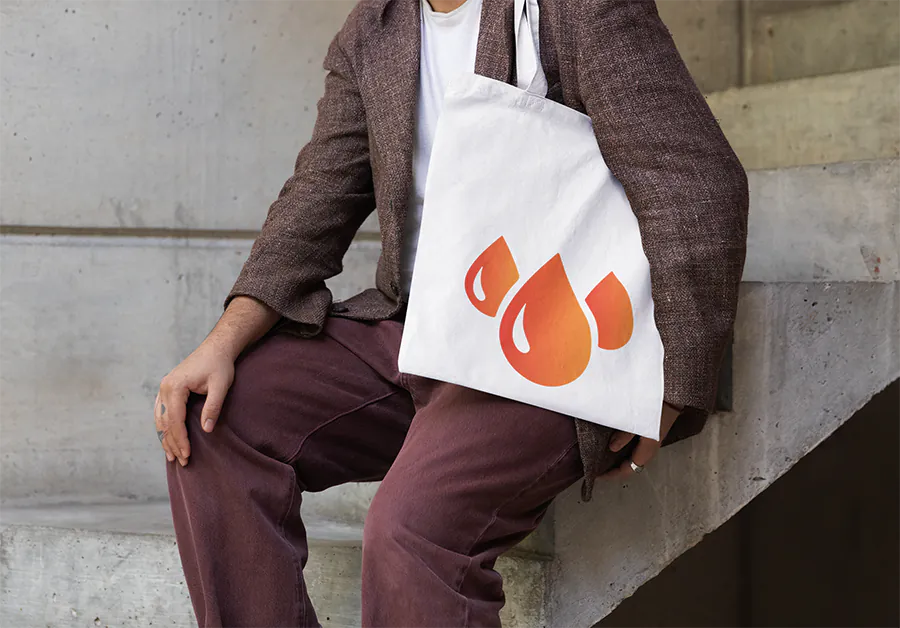 tote-bag-mockup-featuring-a-cropped-face-person-sitting-on-a-staircase-m39801